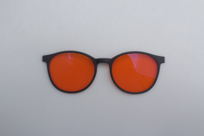 Blue Blocking glasses with orange lenses and black frames on a white background