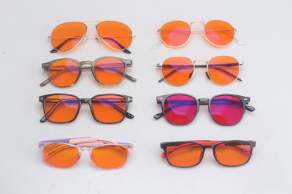 Collection of blue light blocking glasses on a light gray background