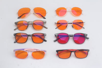 Collection of blue light blocking glasses on a light gray background