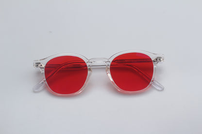 Blue Light blocking glasses (blålysbriller) with red lenses and clear frames on a light gray background