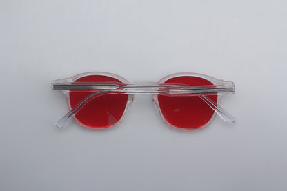 Blue Light blocking glasses (blålysbriller) with red lenses and clear frames on a white background
