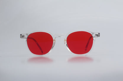 Blue Light blocking glasses (blålysbriller) with red lenses and clear frames on a light gray background