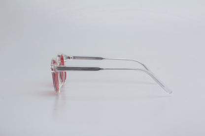 Blue Light blocking glasses (blålysbriller) with red-tinted lenses on a light gray background