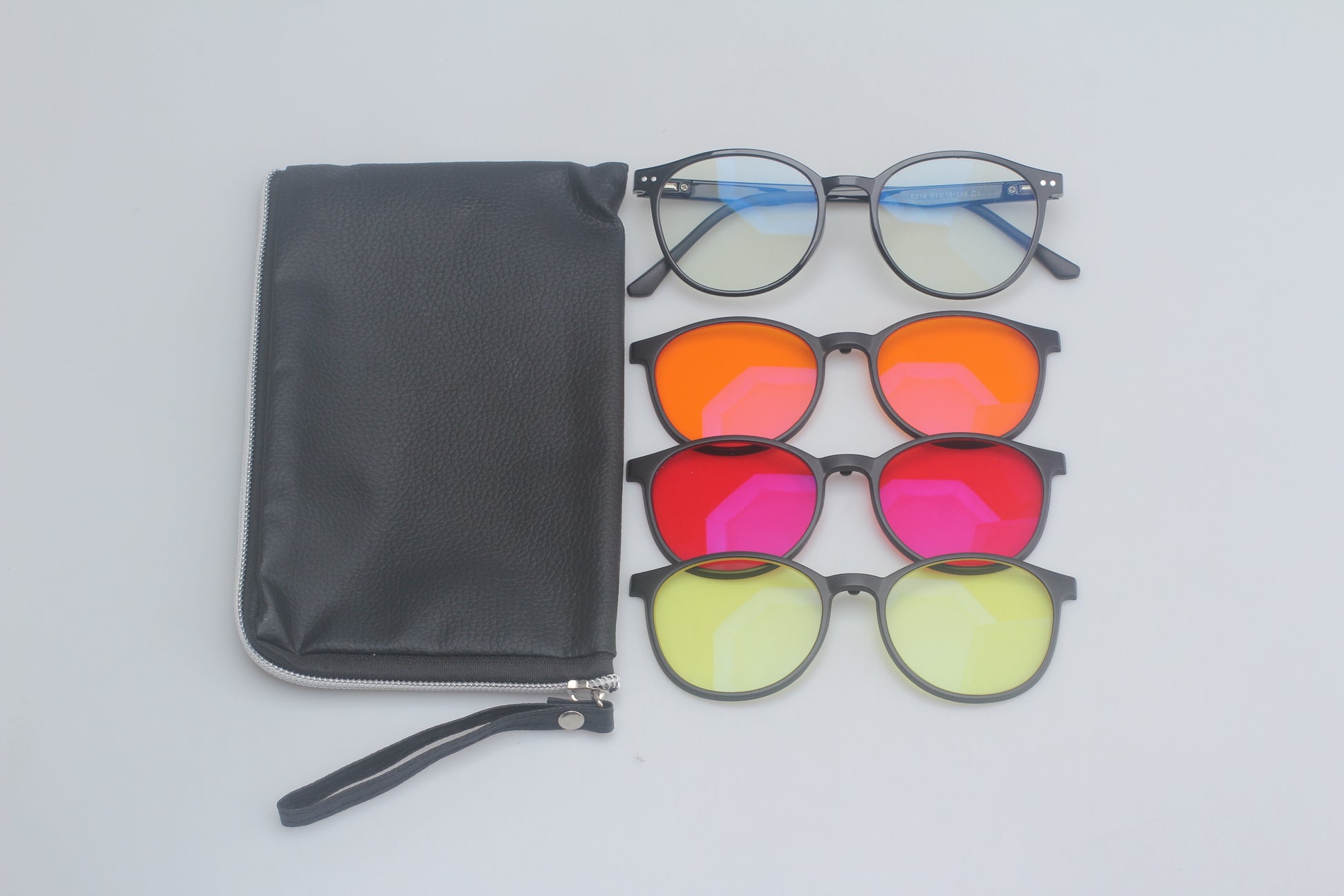 Set of Blue Light blocking glasses with a black pouch on a light gray background