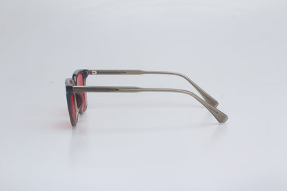 Blue light blocking glasses with red lenses and thin metal frame on a white background