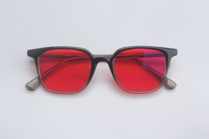 Blue Light blocking glasses with red lenses and black frames on a white background