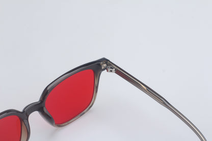 Blue light blocking glasses with red lenses and black frame on a white background