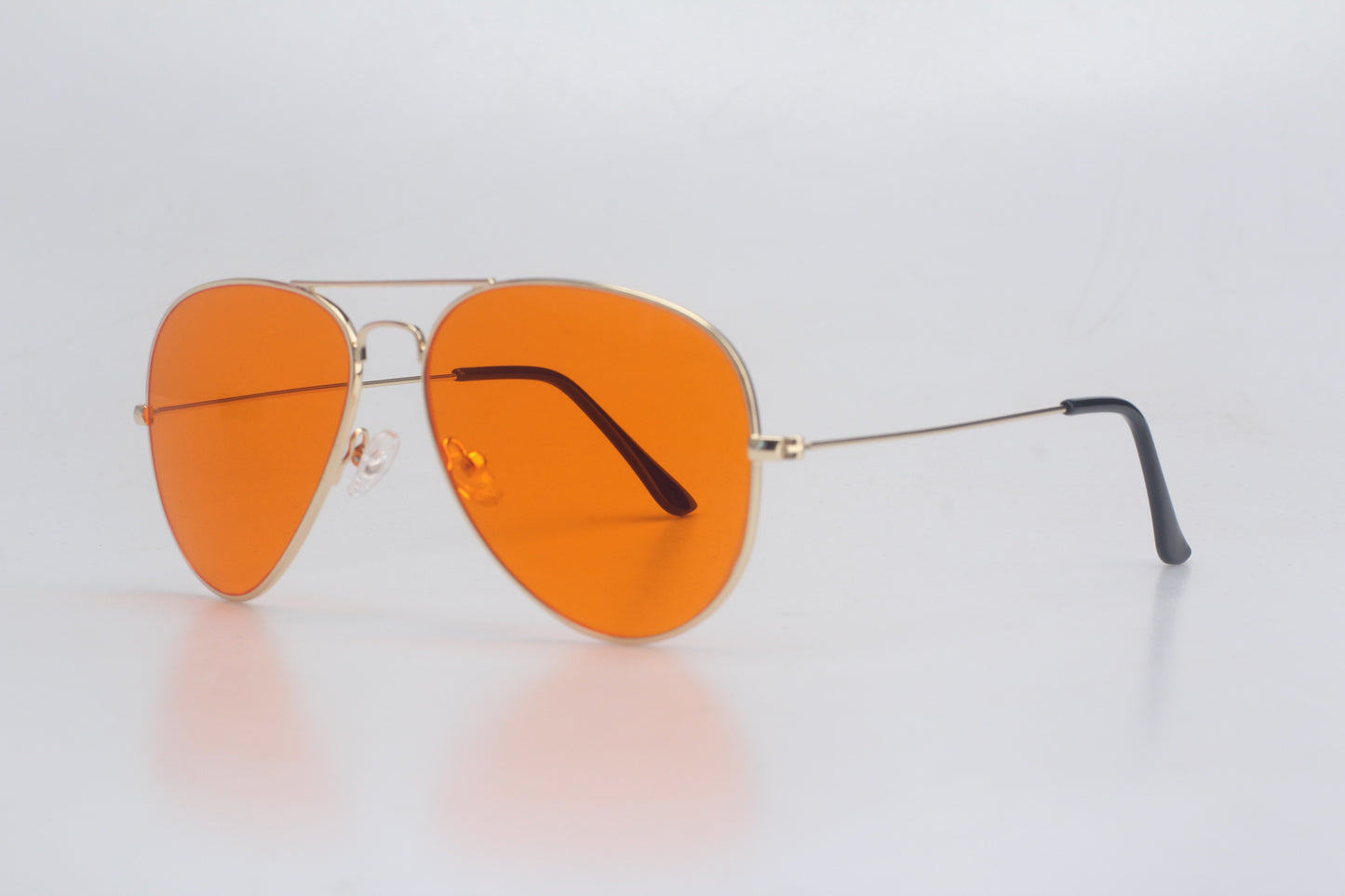 Aviator Blue Light blocking glasses with orange lenses on a light gray background
