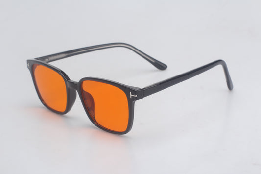 Blue Light blocking glasses with orange lenses and black frames on a light gray background